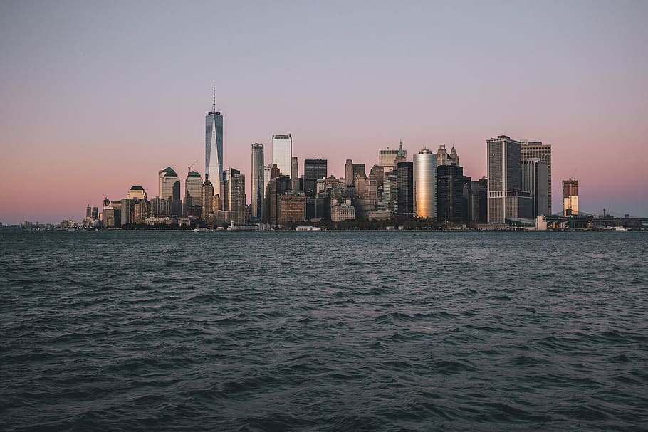brown and white concrete building near body of water, photo of cityscape HD wallpaper