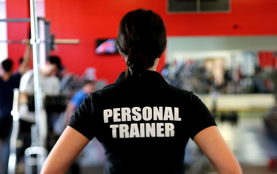 focus photo of woman wearing Personal Trainer shirt, trainers, HD wallpaper