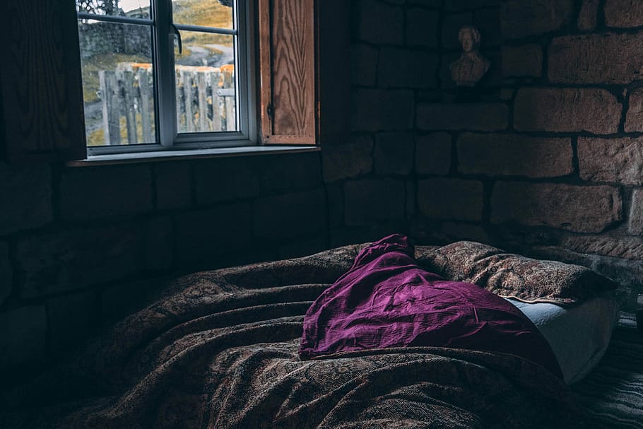 person laying on bed, brown blanket near window, brick, wall, HD wallpaper