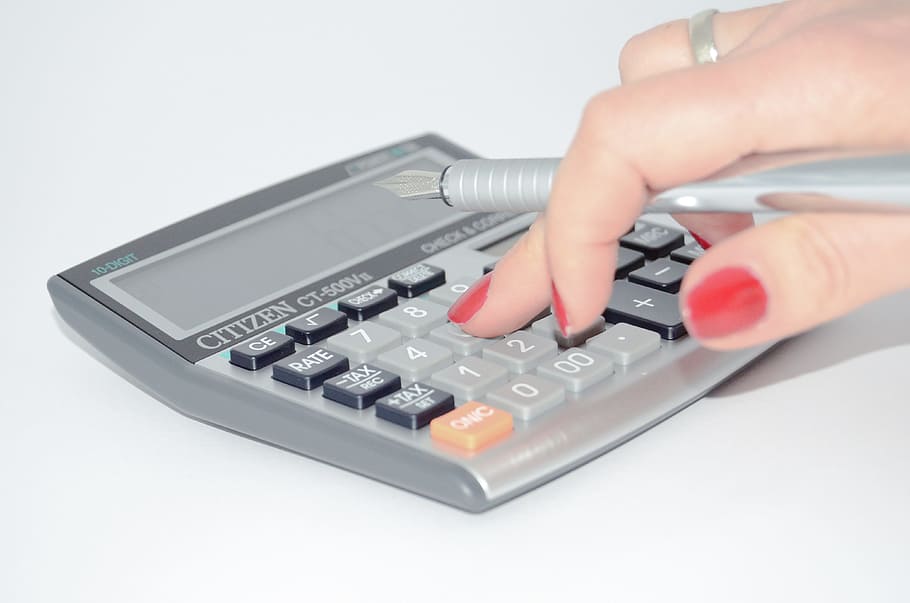 person pressing button on desk calculator, the hand, calculate