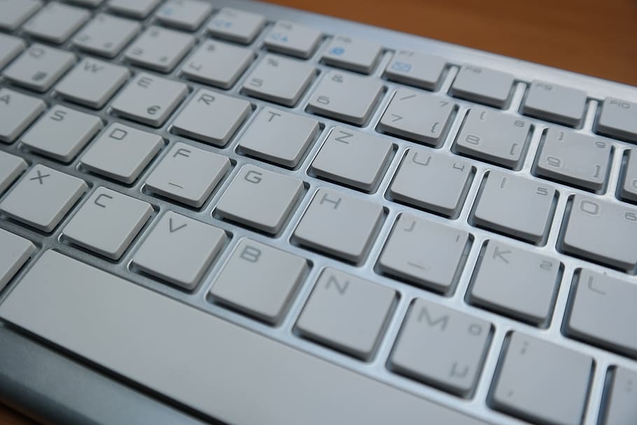 grey and white computer keyboard on brown surface, letters HD wallpaper