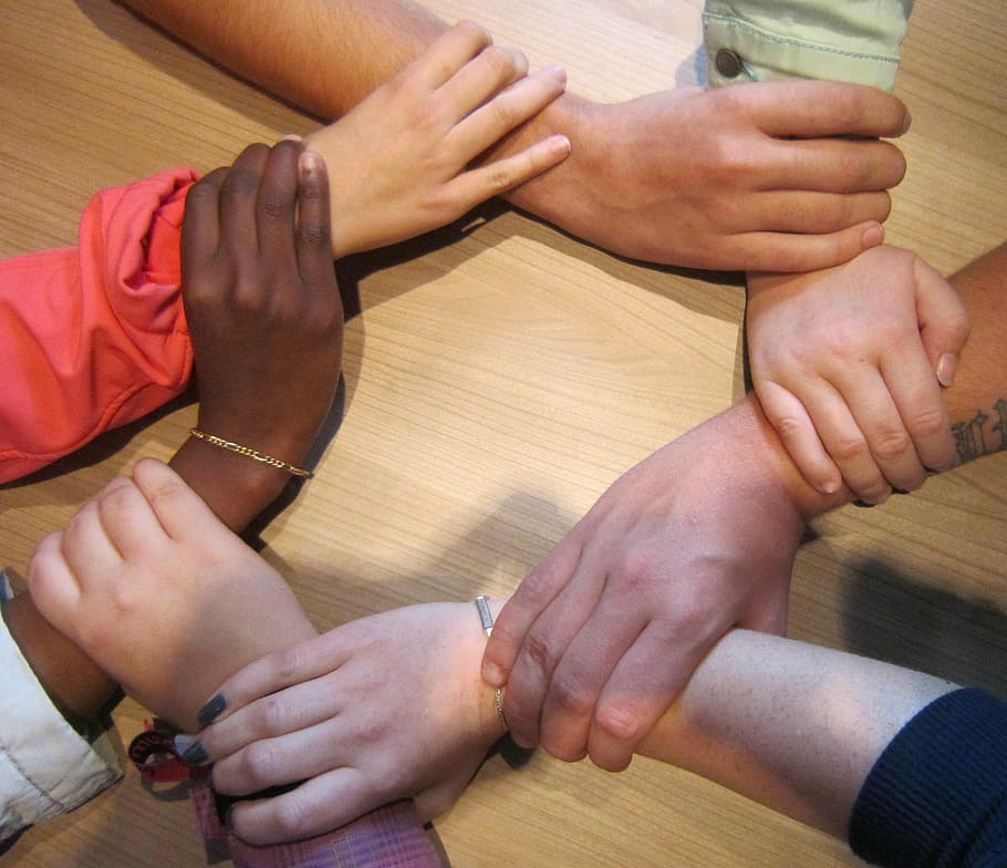 people holding wrists, together, team, circle, hands, group, support