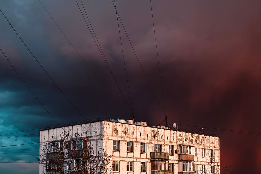 building near smoke, shallow focus photography of white establishment under the cloudy sky HD wallpaper