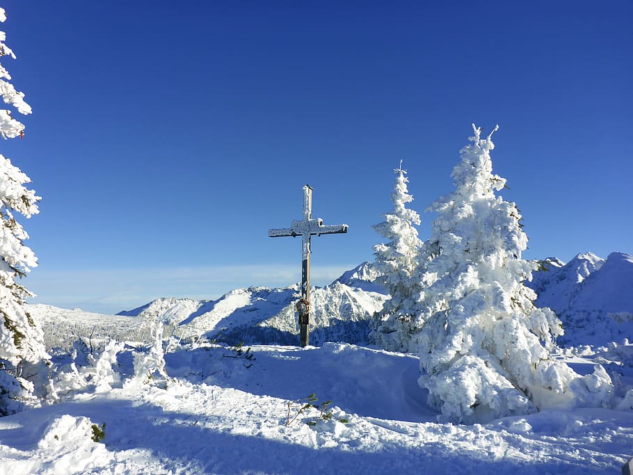 brown cross covered by snow near mountain and trees, winter, summit cross