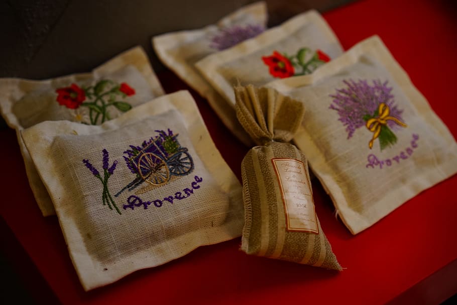 white and purple textile on red surface, sachet, lavender pillow