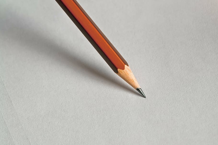 macro photography of brown pencil tip on white surface, office