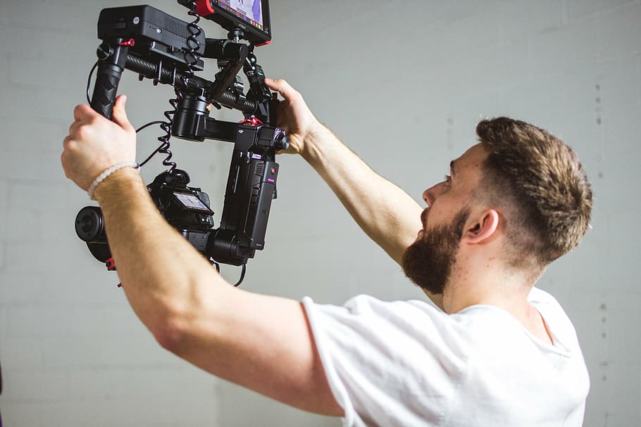 man holding camera stabilizer, people, guy, operator, video HD wallpaper
