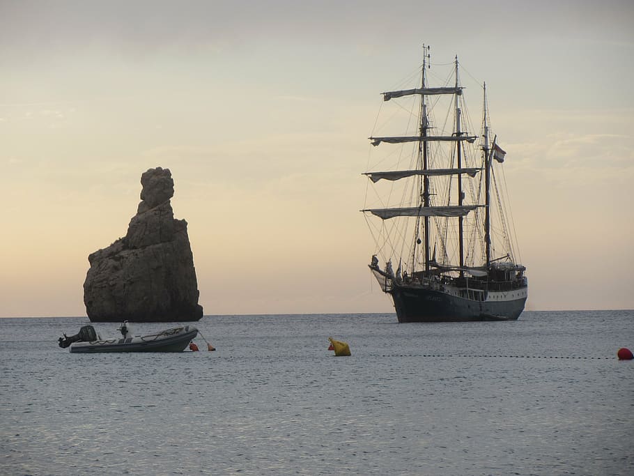 black ship near rock, ibiza, sunset, nautical vessel, water HD wallpaper