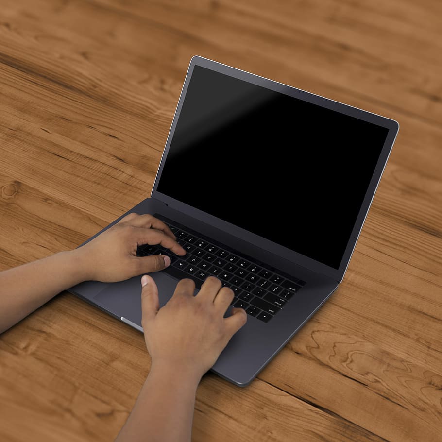 black laptop computer on brown surface, person touches laptop computer HD wallpaper