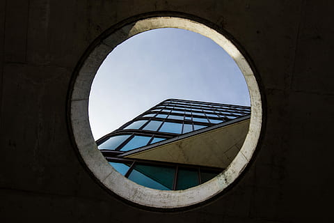 low angle photography of high-rise building, worm's-eye view photography of blue glass-panel building on hole HD wallpaper