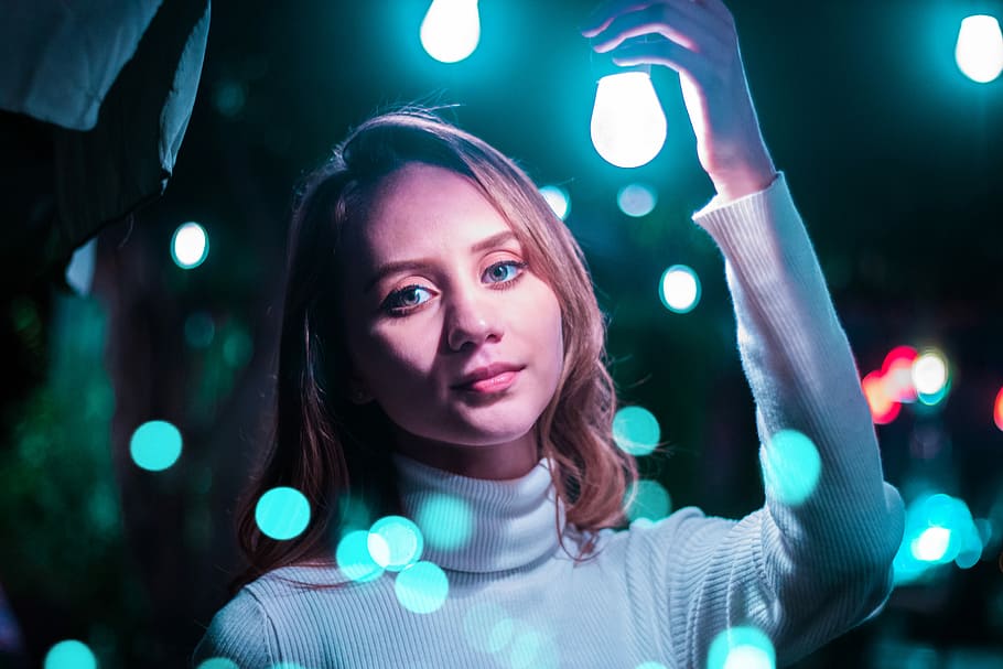 The light on my way, woman holding blue lightbulb, blonde, turtleneck HD wallpaper