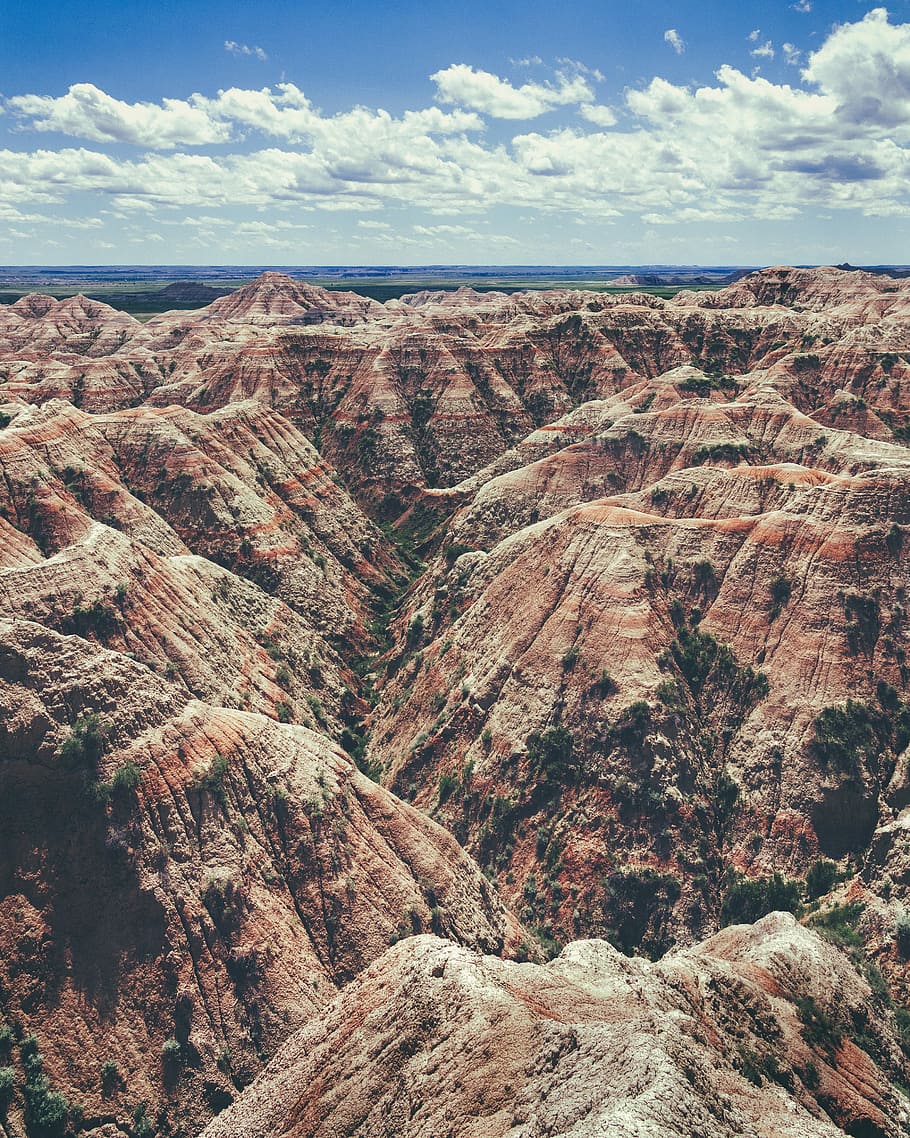 aerial photography of brown rock formation, brown mountain range during daytime HD wallpaper