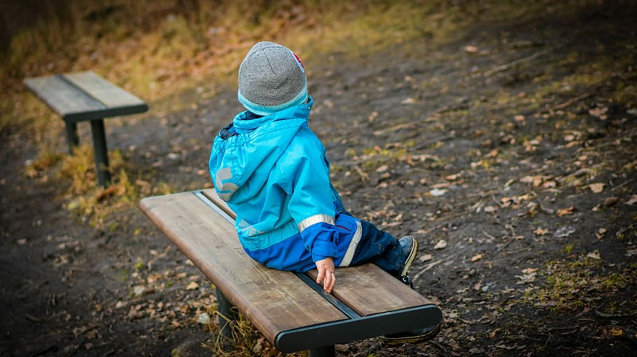 baby in blue jacket sitting on bench, Boy, son, young, looking away