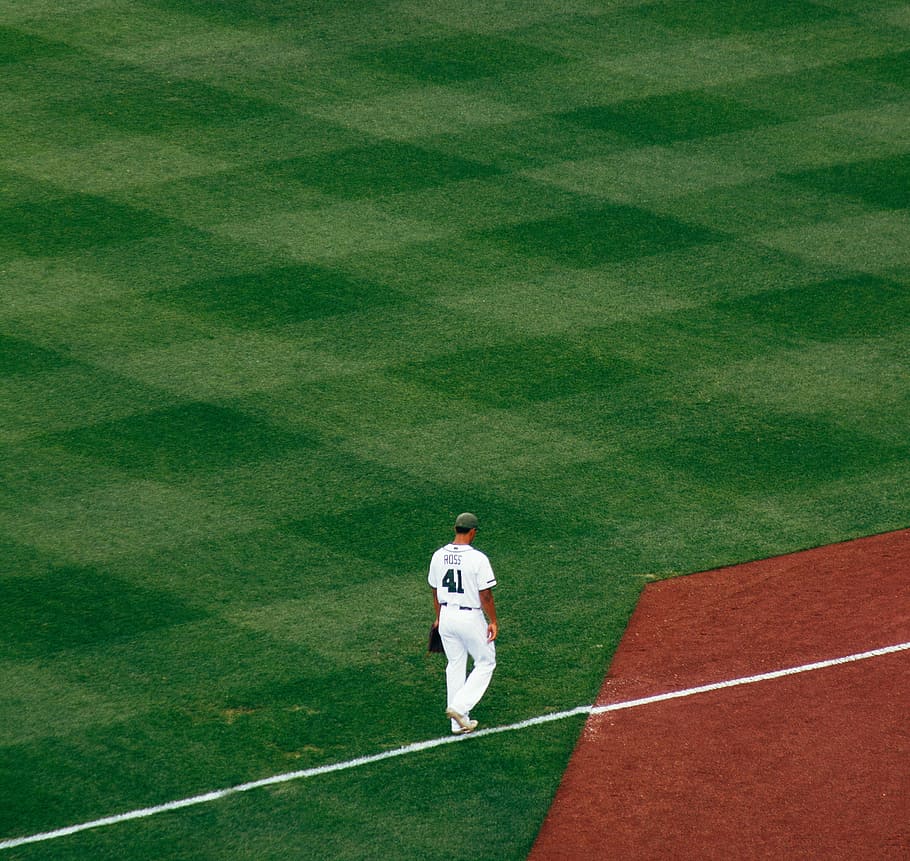 baseball player standing on field steps on white line at daytime, baseball player standing on the field HD wallpaper