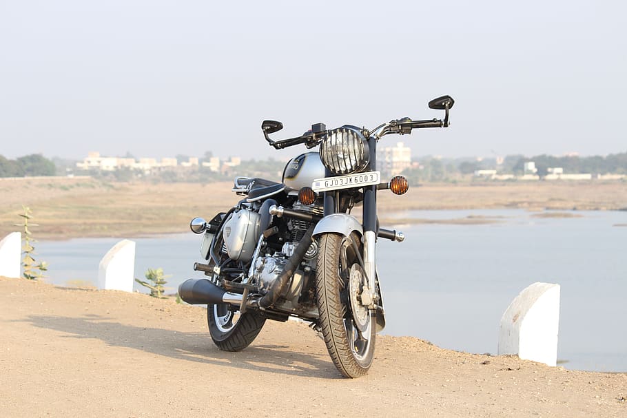 black and gray cafe racer near body of water, royal enfield, bullet