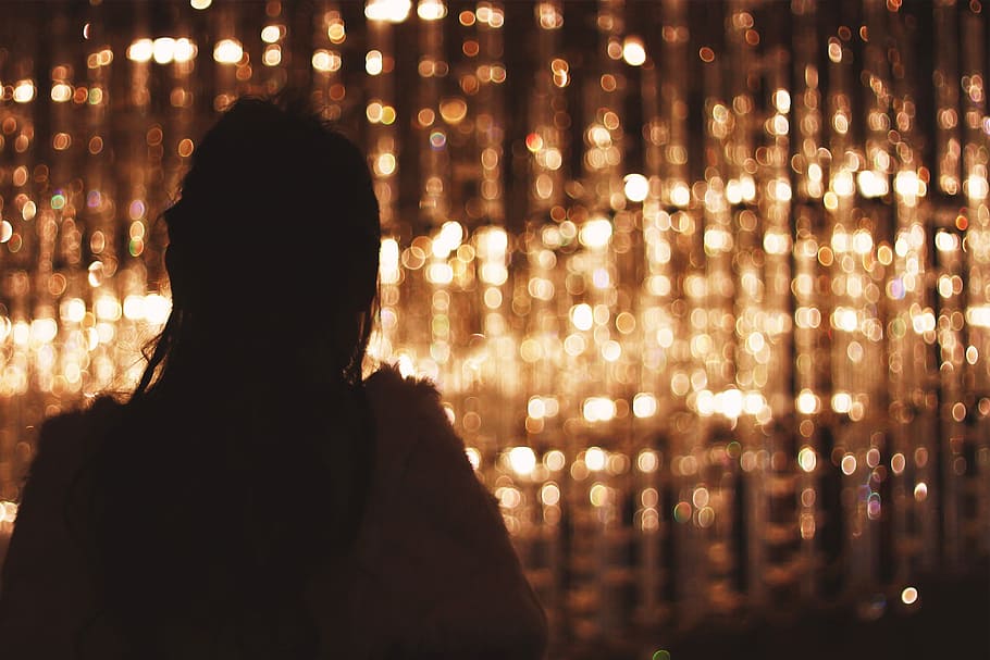 silhouette  photography of woman standing near brown lights, night HD wallpaper