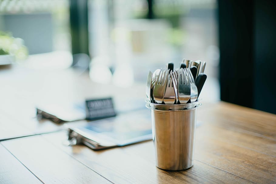 selective focus photography of cutlery on bucket, silver cutlery lot on table top HD wallpaper