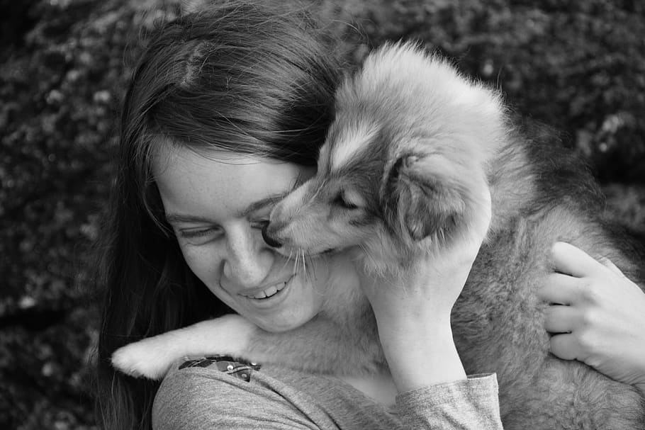 grayscale photo of woman hugging puppy, kiss, kisses dog, girl, HD wallpaper