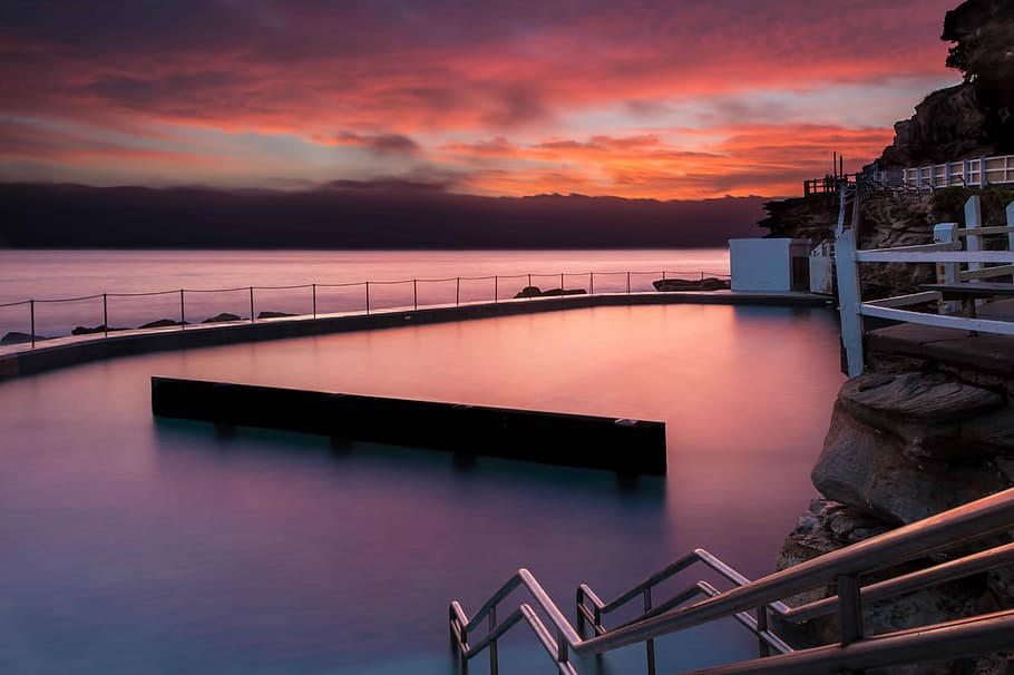 gray metal handrail beside body of water, pool with fog during sunrise HD wallpaper