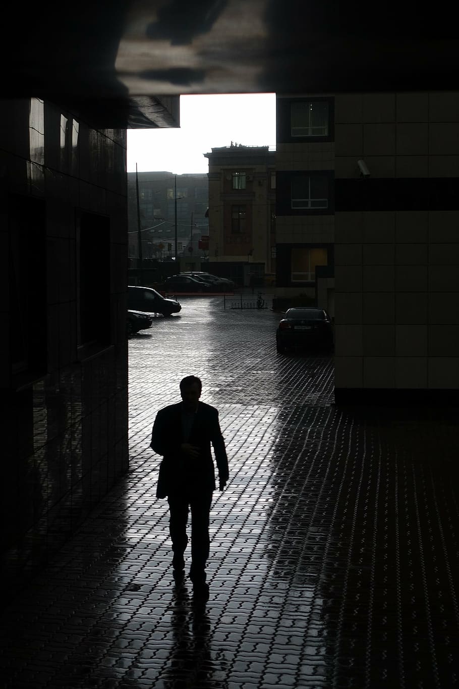 silhouette of man walking inside building, businessman, rain
