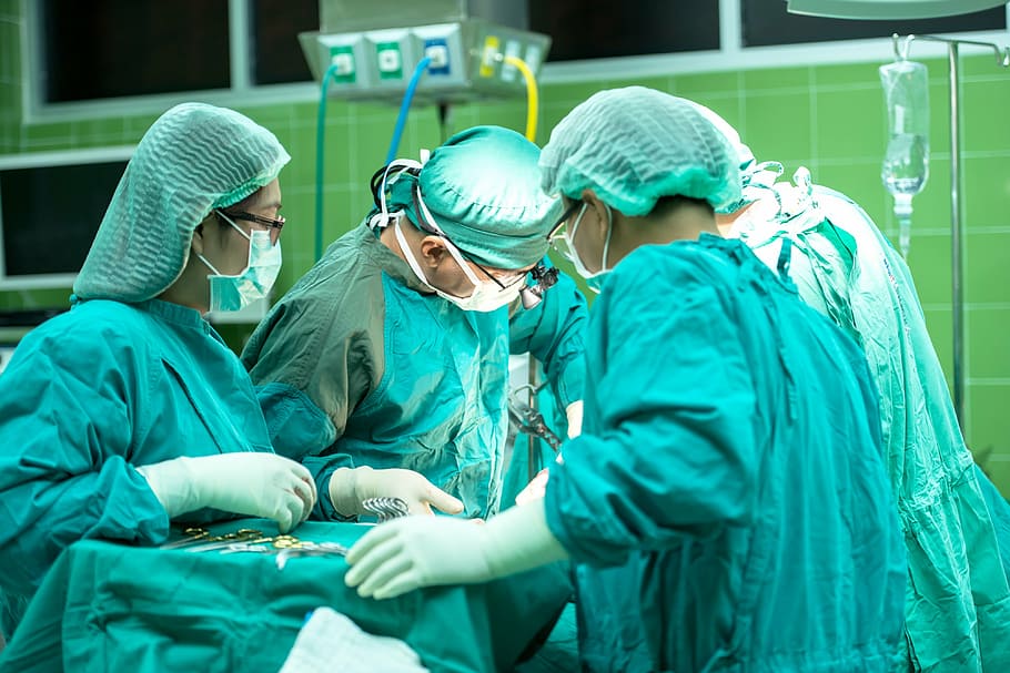 four medical staff with wearing medical gowns while doing surgery, HD wallpaper