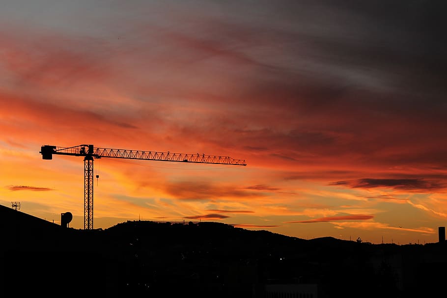 silhouette of crane and hill under cloudy sky photo taken during sunset, selective color photography of sunset HD wallpaper