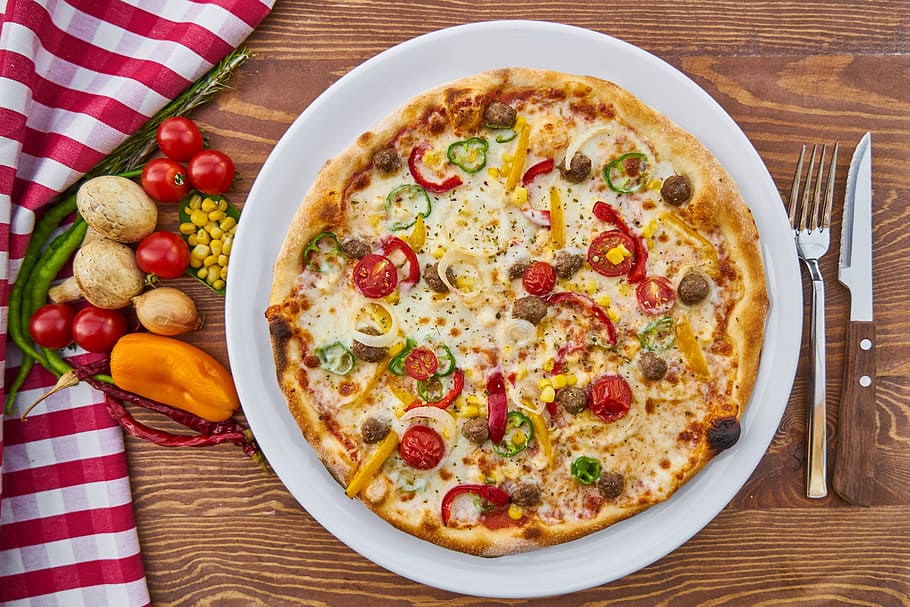 pizza on round white ceramic plate, dough, baked, cheese, tomato