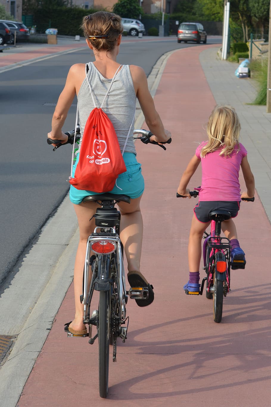 woman wearing orange drawstring bag, cyclists, people, backpack
