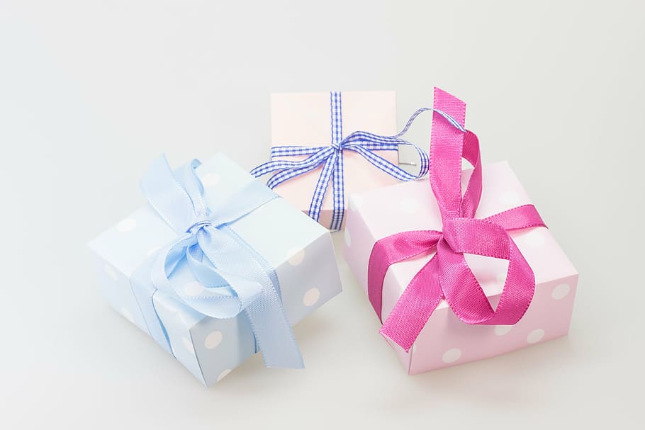 three assorted-color wrapped gifts on white surface, made, surprise HD wallpaper