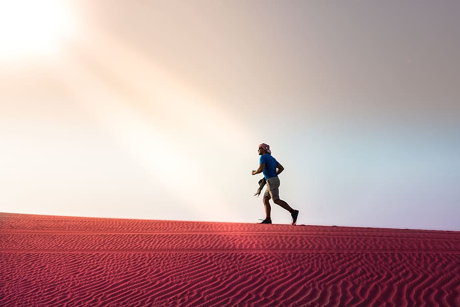 man running on desert during daytime, abu dhabi, sun, nature, HD wallpaper