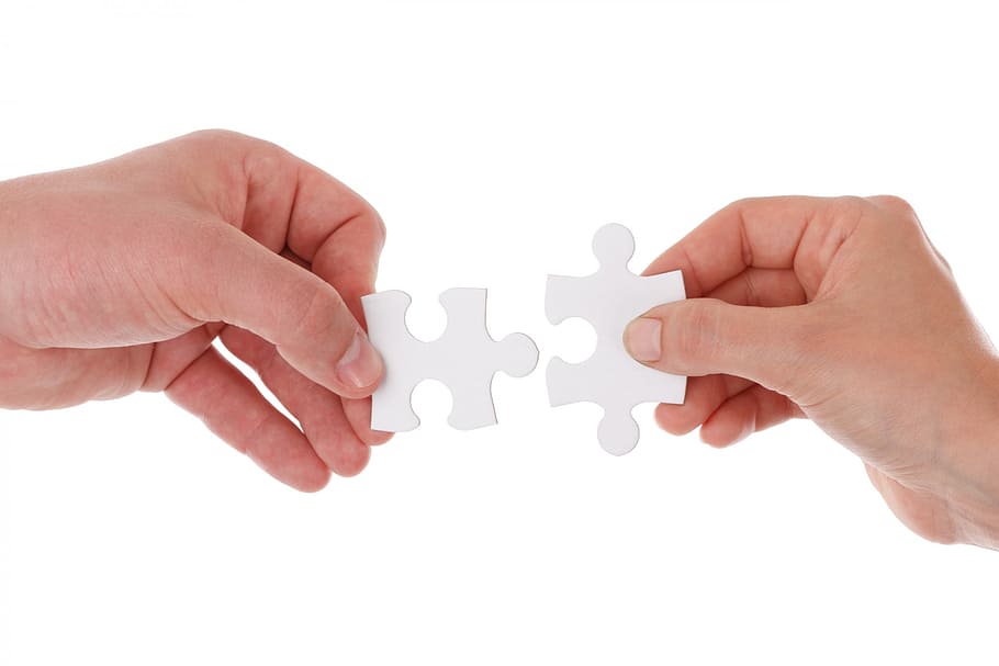 person holding 2-pieces jig saw puzzle, connect, connection, cooperation