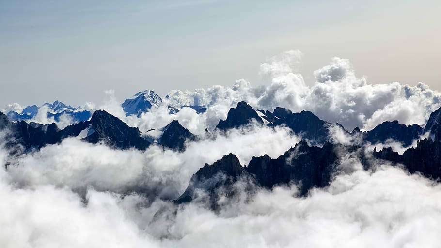 aerial photography of sea of clouds and mountain, photo of mountain covered by snow during daytime HD wallpaper
