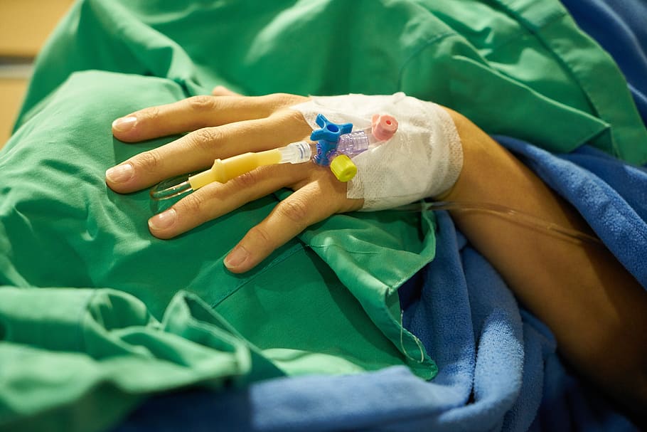 person covered with green and blue cloth, surgery, serum, bandage