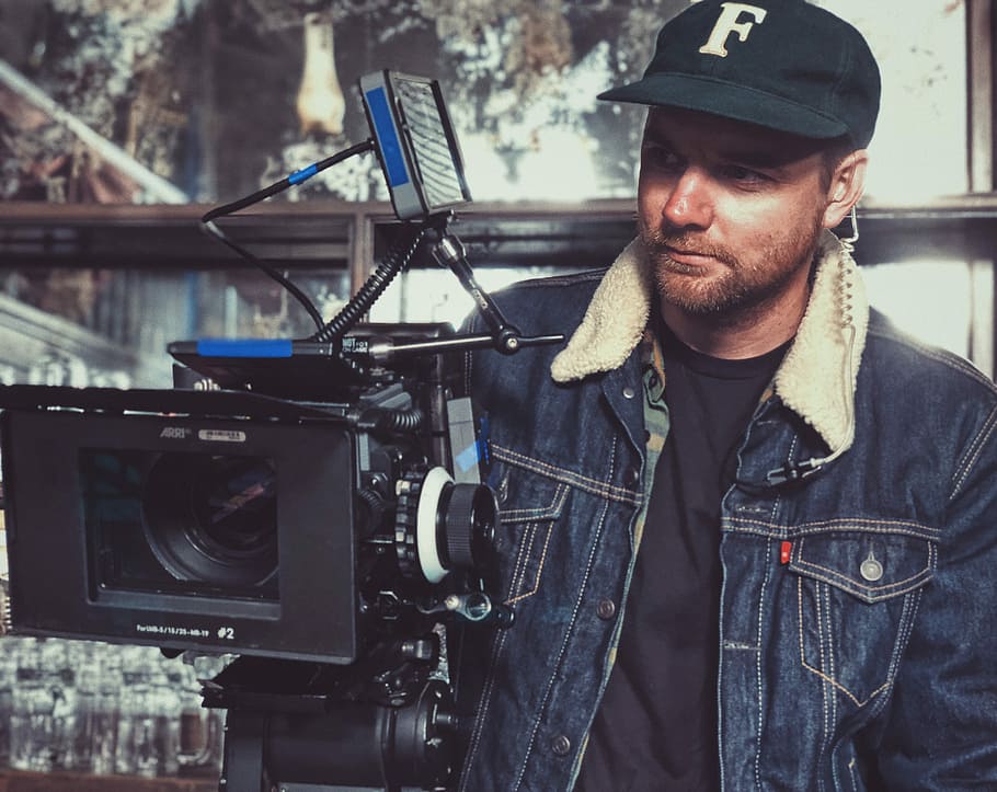 man taking video using studio camera, man standing near black camera HD wallpaper