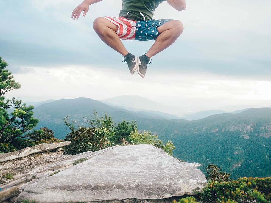 man jumpin in mid air, man jumping on top of cliff, rock, nature HD wallpaper