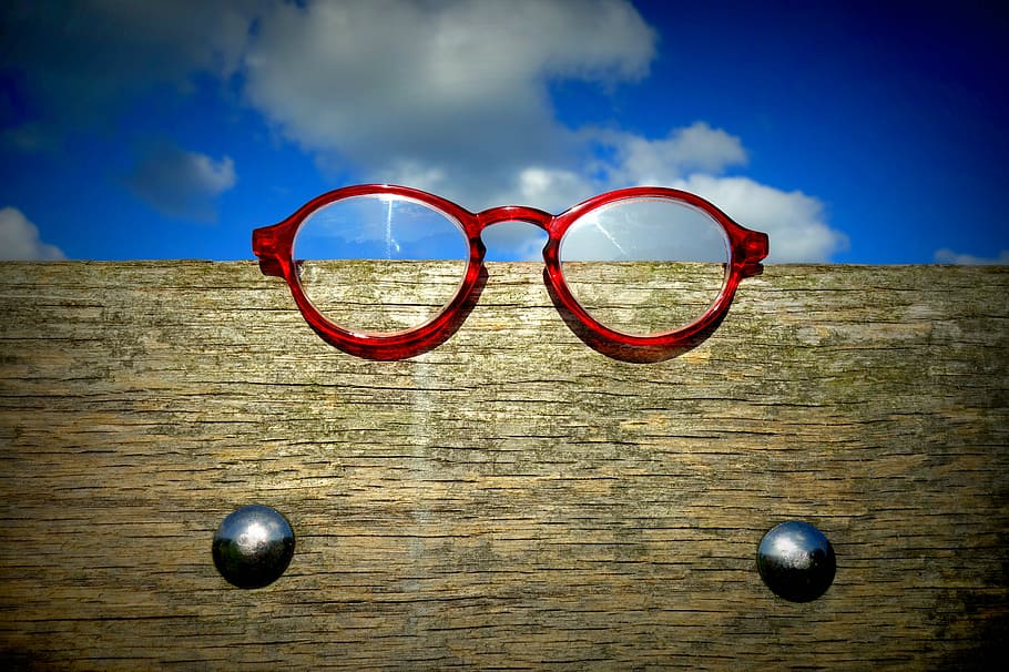 red framed eyeglasses on brown wooden frame, spectacles, eye wear