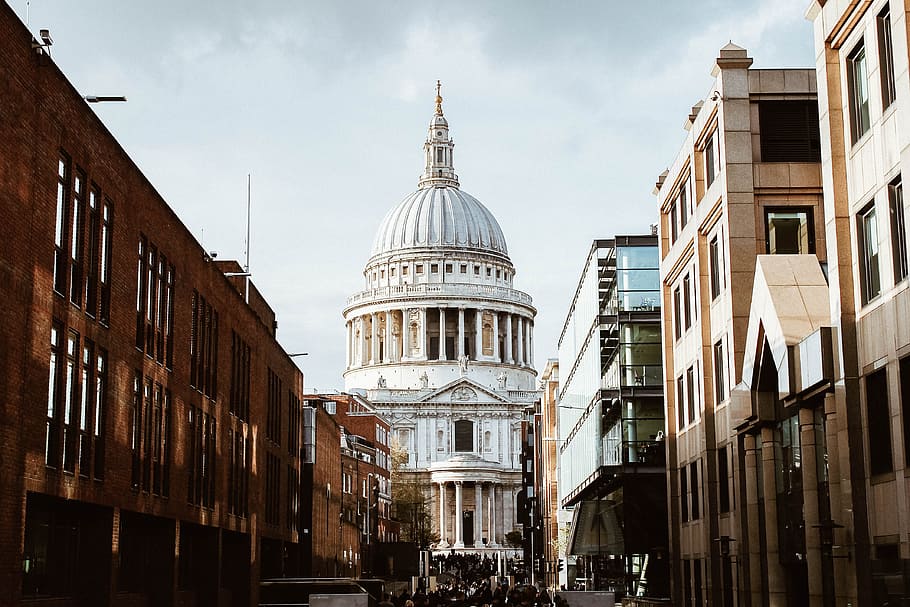 white building with dome under white clouds during daytime, hallway between concrete buildings near white cathedral HD wallpaper