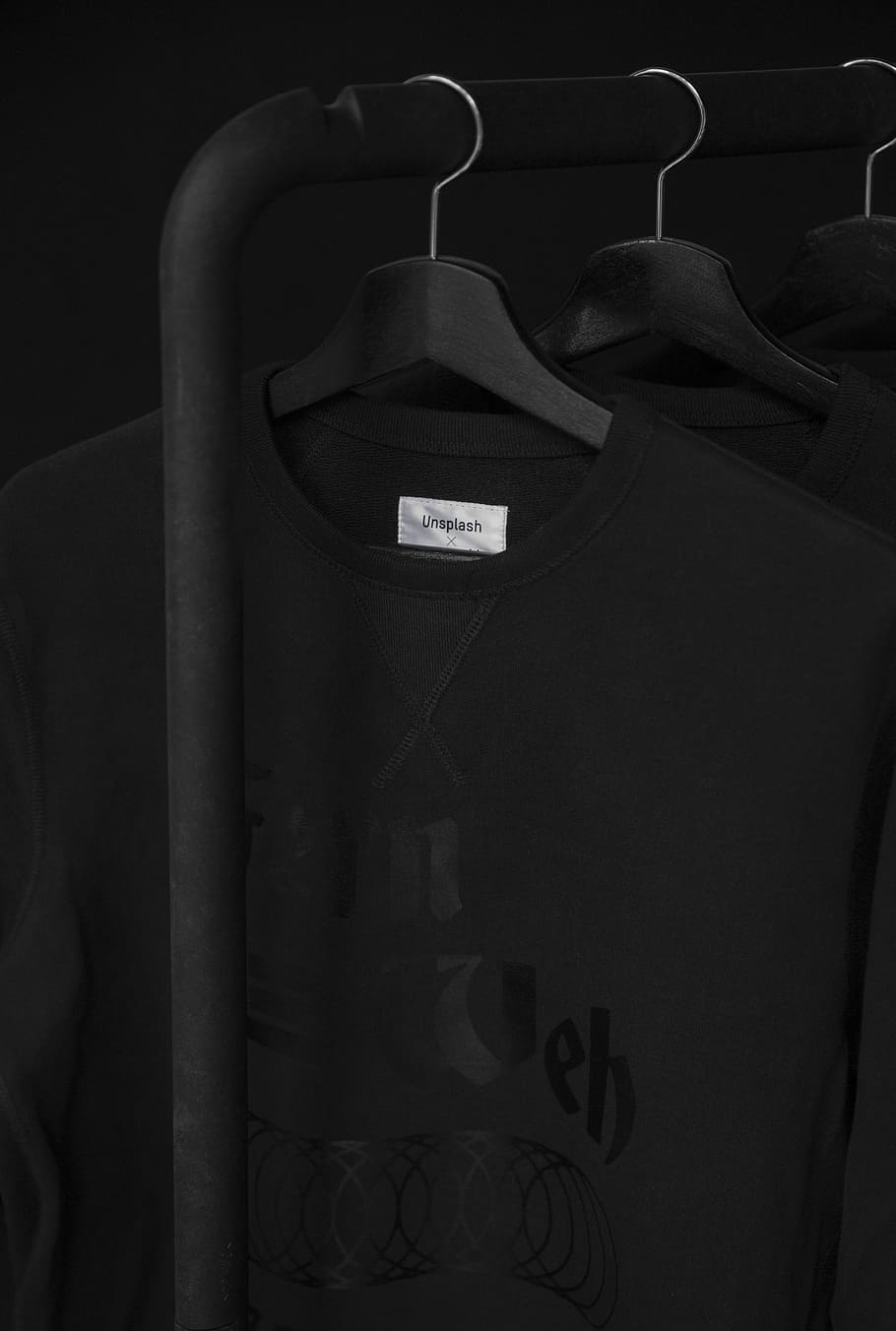 black crew-neck t-shirt on clothes hanger, black T-shirt, unsplash clothing