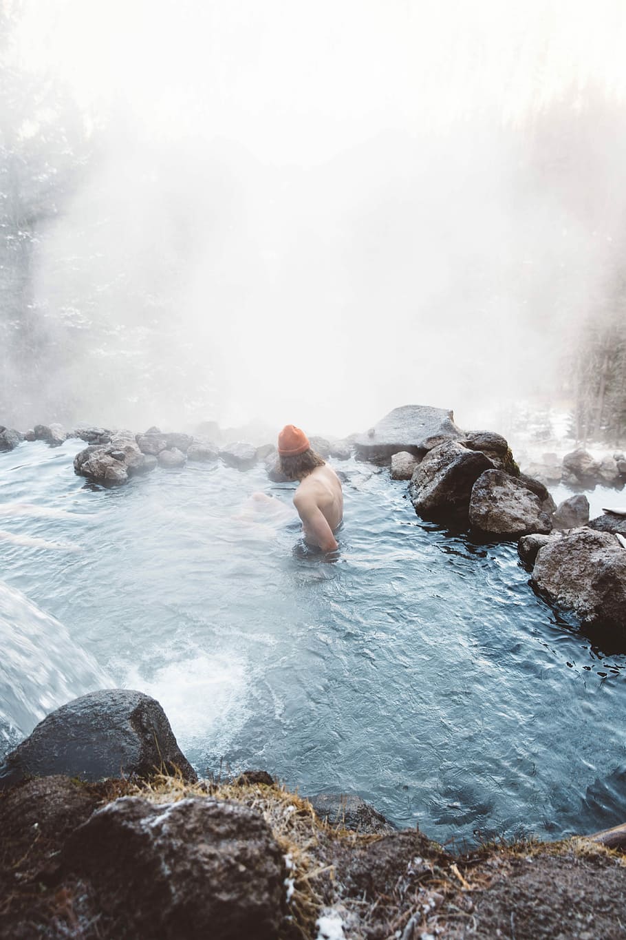 man sitting in water with fog during daytime, man soaking in body of water surrounded with fog HD wallpaper