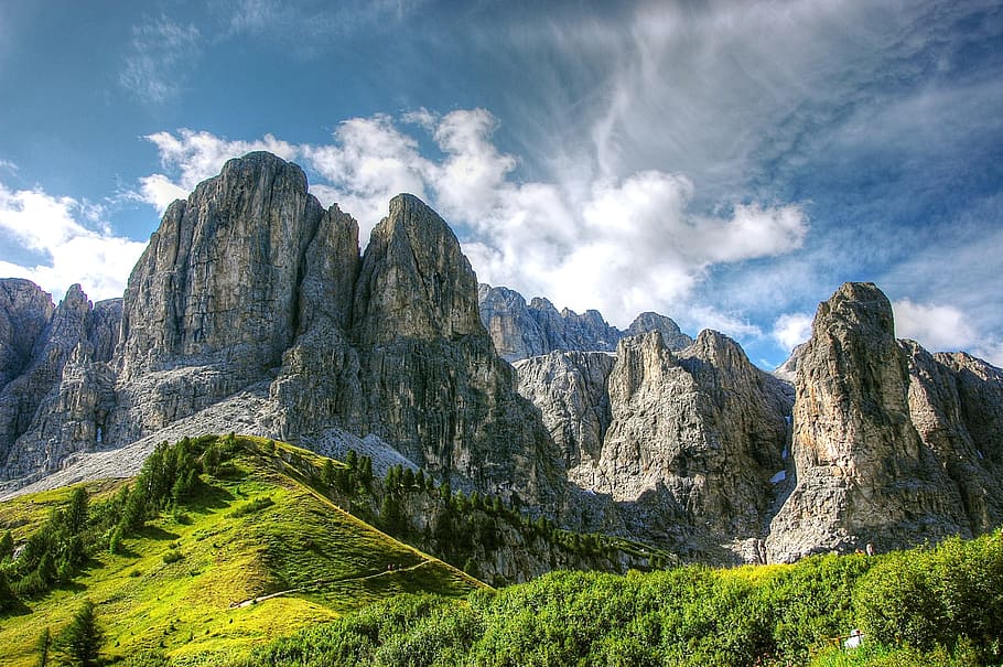 brown rock formations under cloudy blue sky during daytime, dolomites