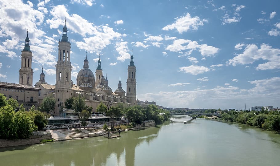 white building near river under cloudy skies, saragossa, ebro HD wallpaper