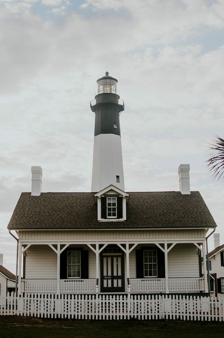 white lighthouse under white sky, lighthouse behind wooden house HD wallpaper