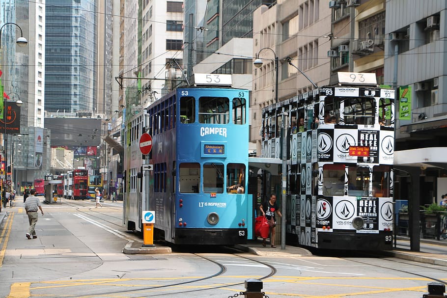 two parked cable double decker buses near building, Hong Kong, Tram