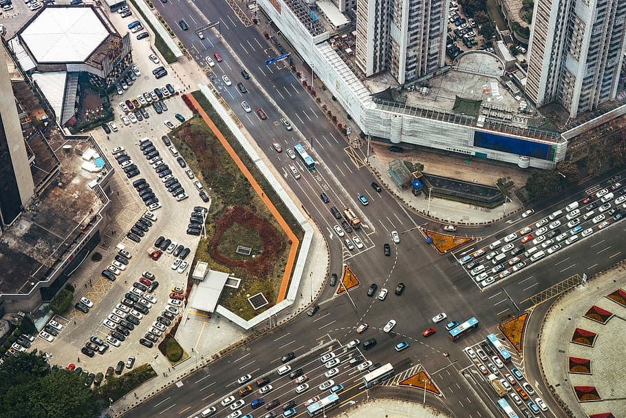 bird's eye view photography of roads, vehicles, and high-rise buildings