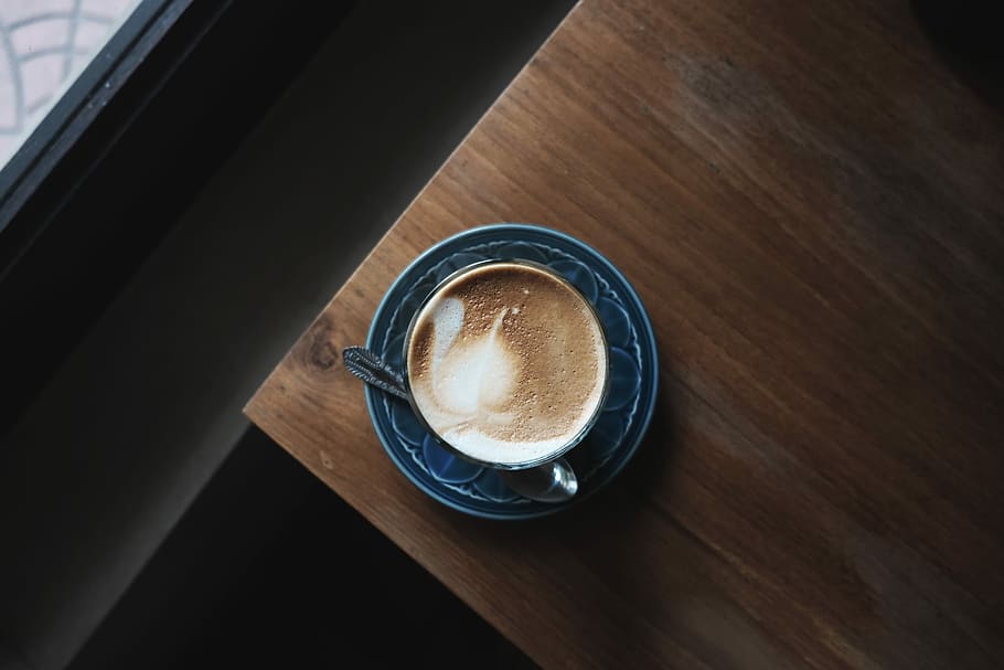 brown liquid on blue ceramic teacup, top view photo of mug with coffee art HD wallpaper