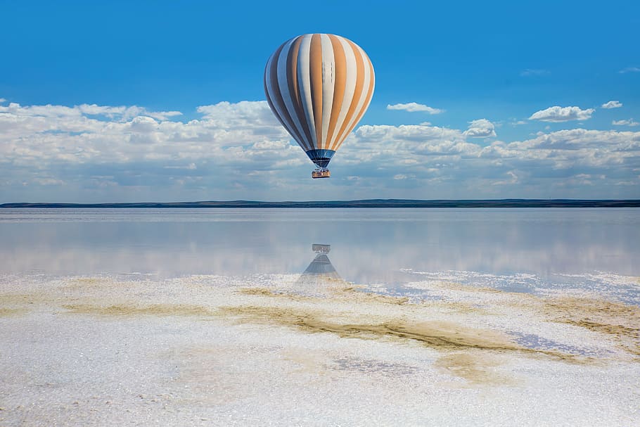 yellow and white hot air balloon above clear water under white clouds and blue sky during daytime, HD wallpaper
