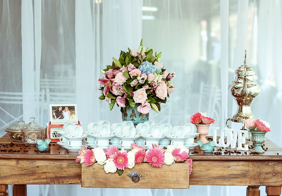flower arrangement behind teacups and saucers on table, ceramic HD wallpaper