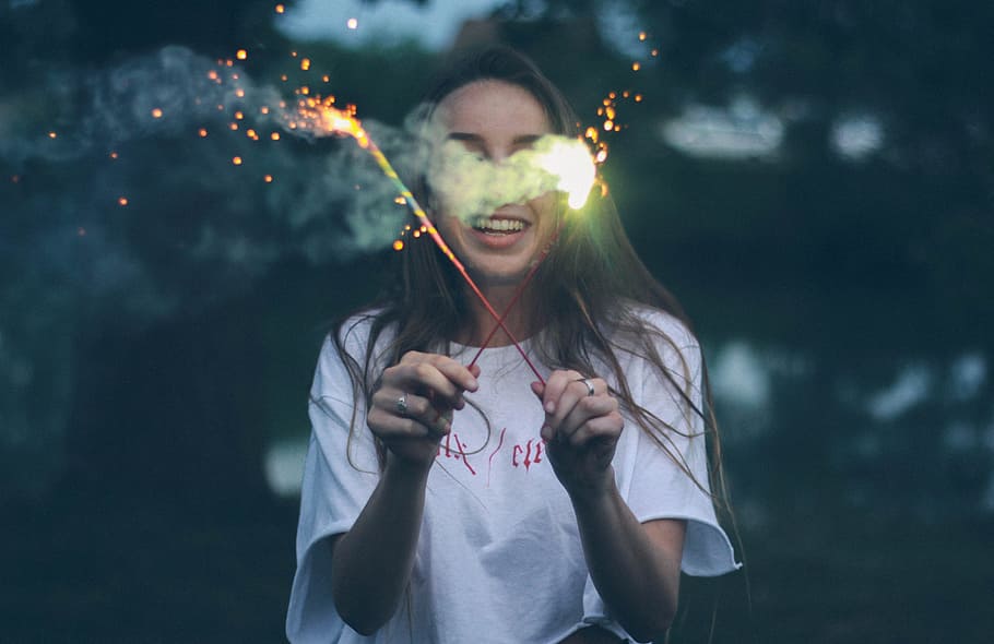 woman holding two sparklers, person holding a fireworks, people HD wallpaper