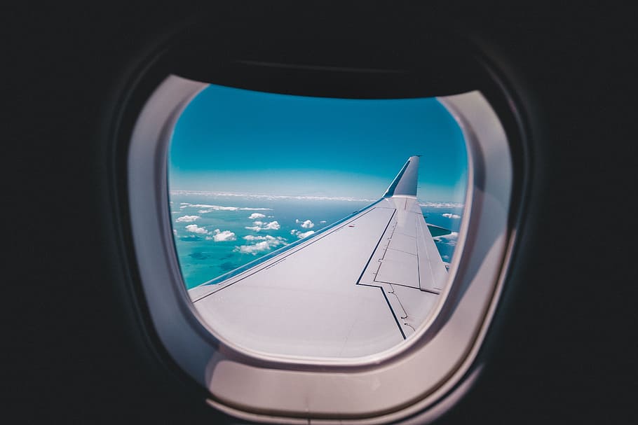 photo of airplane wing, photograph of flying airplane wing viewed inside windshield