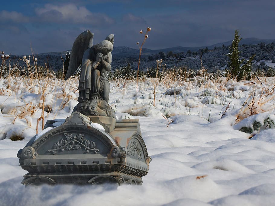 angel statue surrounded snow, cemetery, graveyard, tombstones